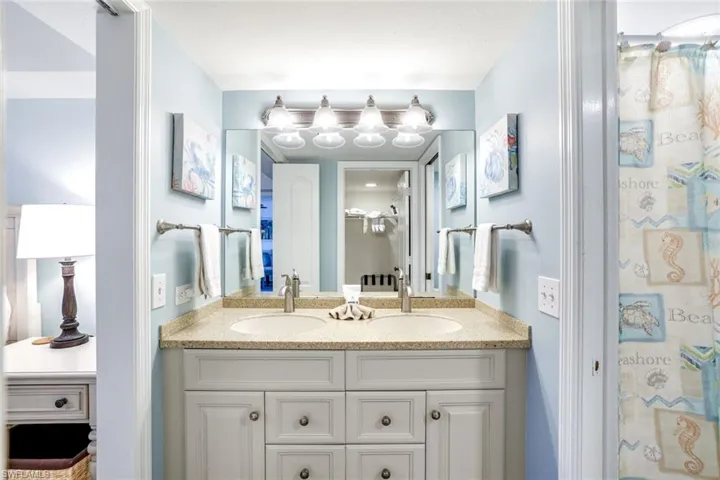 Bathroom with double vanity and curtained shower