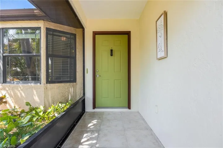 Screened Front Entrance. Notice updated black framed double pane windows.