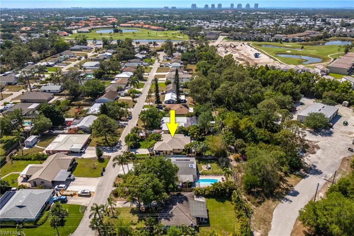 Aerial view with view of end of street cul de sac, town maintenance building on right.