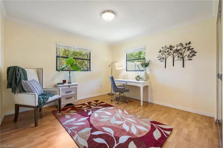 Bedroom 2, currently set up as a home office. Laminate floors and 2 windows for great natural lighting.