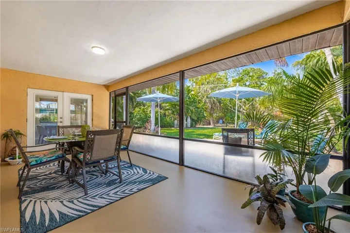 Lanai with views of gorgeous landscaped back yard and outdoor patio space.