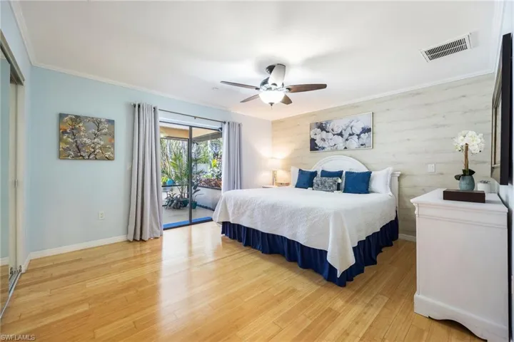 Primary Bedroom with access to Lanai, full wall of closet doors.