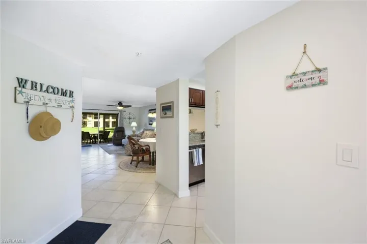 Hall featuring light tile patterned floors