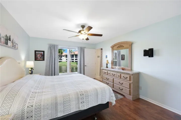 Bedroom with dark wood-type flooring and ceiling fan