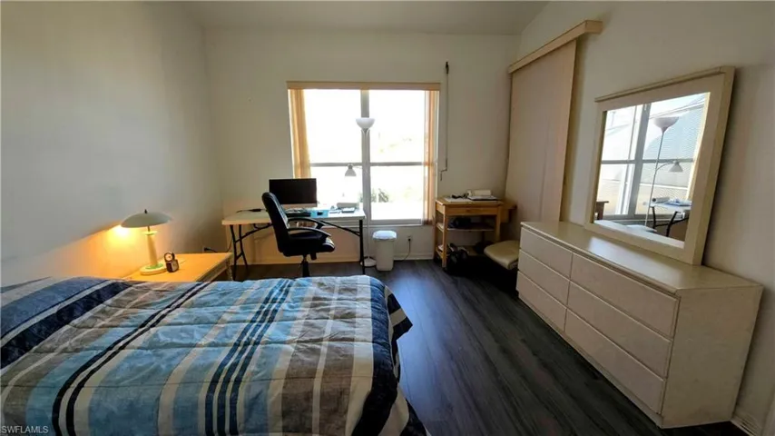 Bedroom with dark wood-type flooring
