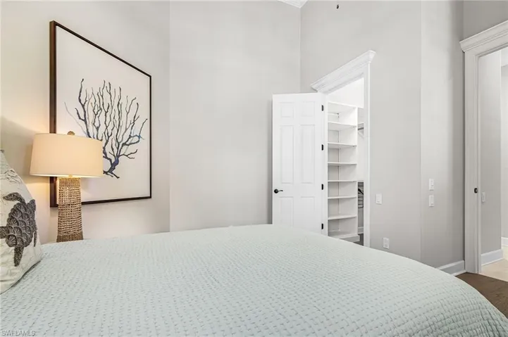 Bedroom featuring wood finished floors and a walk in closet