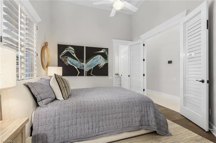 Bedroom featuring Vietnamese wood floors, double doors, guest bath and ceiling fan