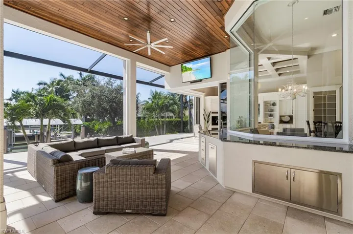 Expansive outdoor kitchen with warming tray. Entertain while the game is on the large screen TV.