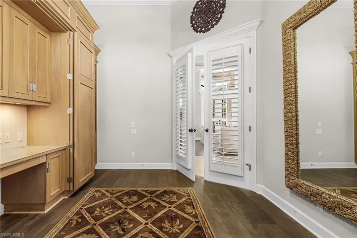 Den/Office with double doors and Vietnamese wood flooring.