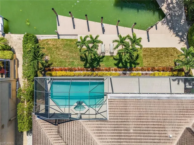 Aerial of 136 ft seawall, infinity heated saltwater pool, large deck and 60-ft yacht boat slip.