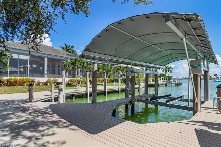 13,000 lb covered boat lift and 60-ft yacht boat slip, plus captains walk, electric, water, fish cleaning station and tide guides.