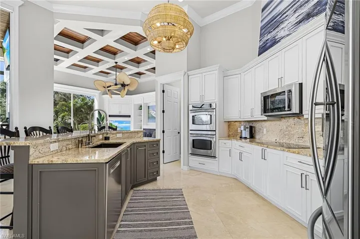 Large kitchen with bar, walk in pantry, double wall oven.