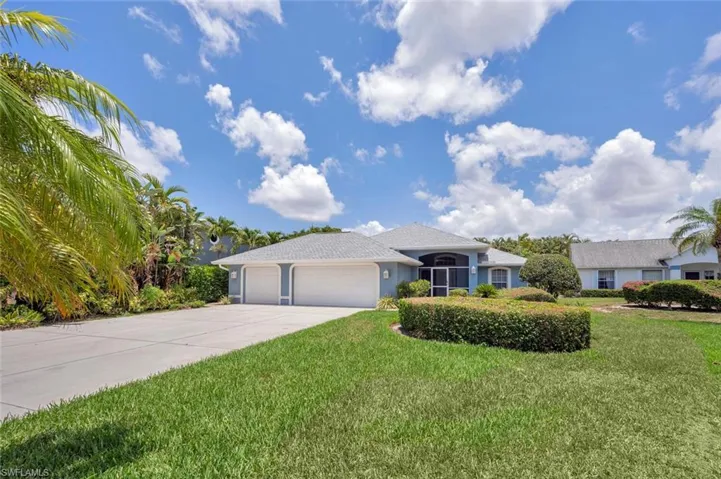 Single story home with a garage and a front yard