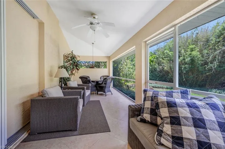 Sunroom featuring ceiling fan and vaulted ceiling