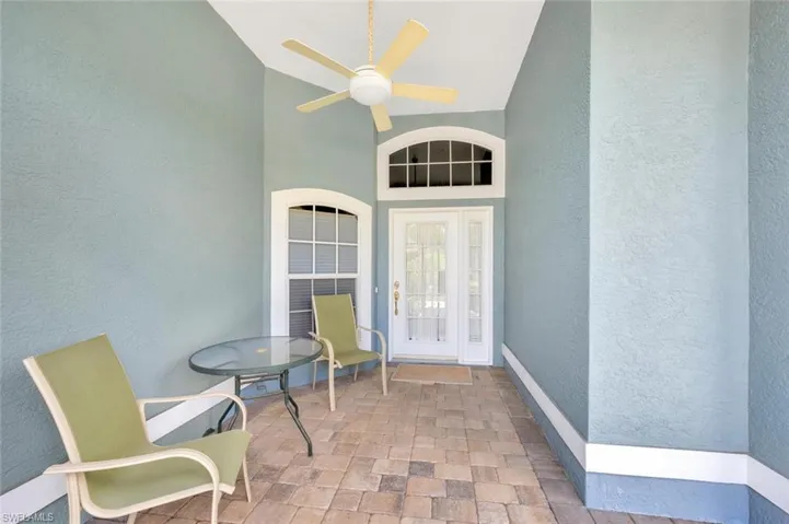 Doorway to property with ceiling fan