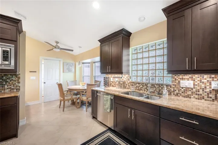 Kitchen featuring ceiling fan, stainless steel appliances, tasteful backsplash, and sink