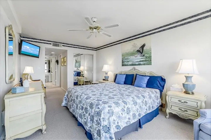 Bedroom with carpet, a closet, and a ceiling fan
