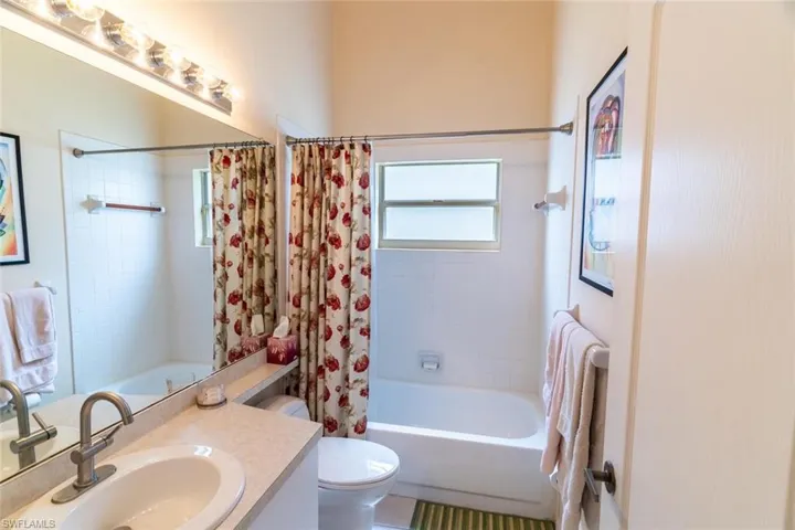 Full bathroom featuring shower / bathtub combination with curtain and vanity