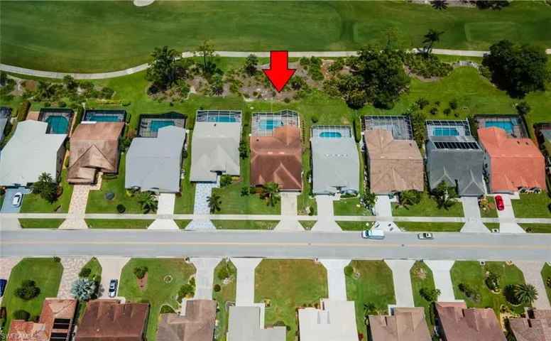 Aerial perspective of suburban area featuring a local golf course