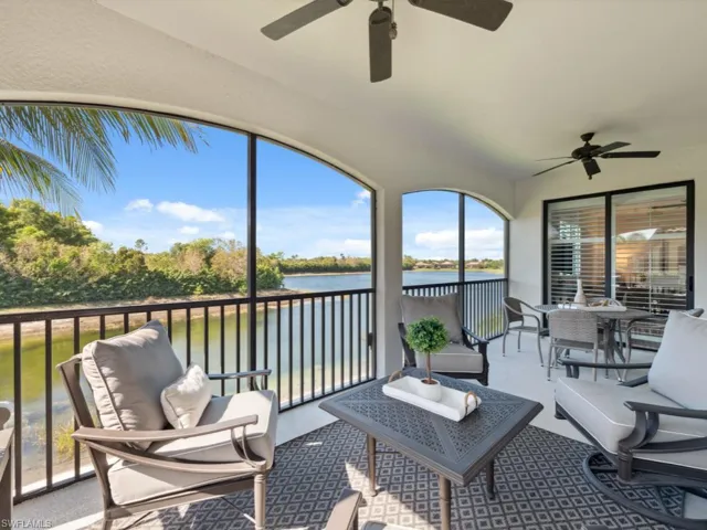 Sunroom / solarium featuring a water view, ceiling fan, and an outdoor living space