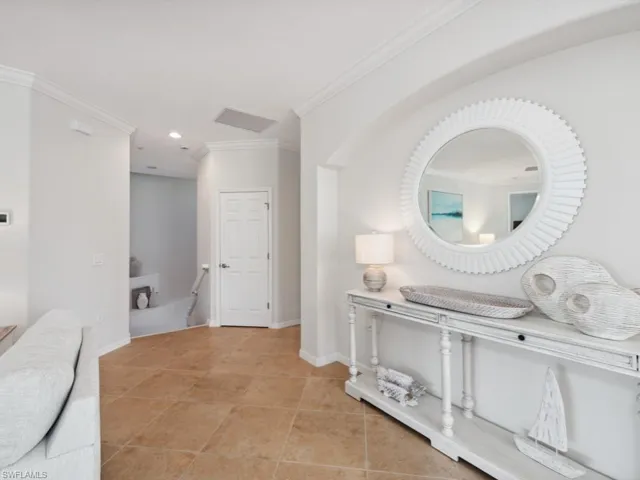 Corridor with ornamental molding, baseboards, recessed lighting, and light tile patterned floors