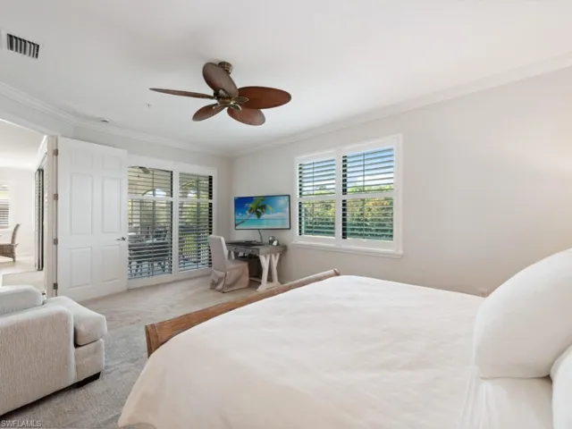 Carpeted bedroom featuring ornamental molding, access to outside, visible vents, and a ceiling fan