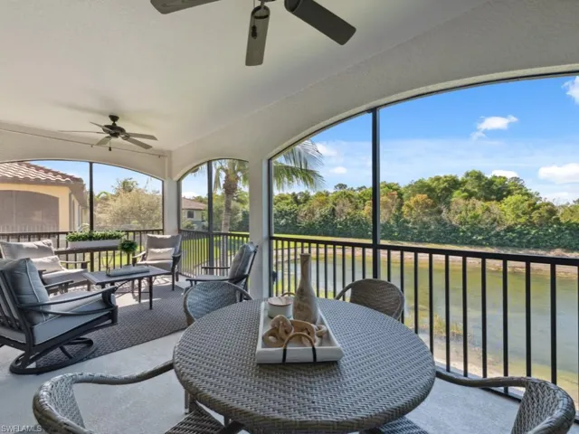 Sunroom with outdoor dining space and ceiling fan