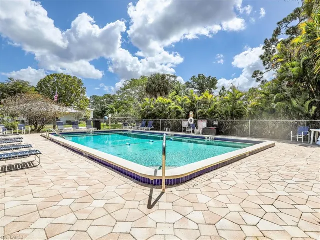 Community pool with a patio