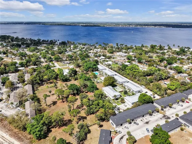 Aerial view of residential area featuring a nearby body of water