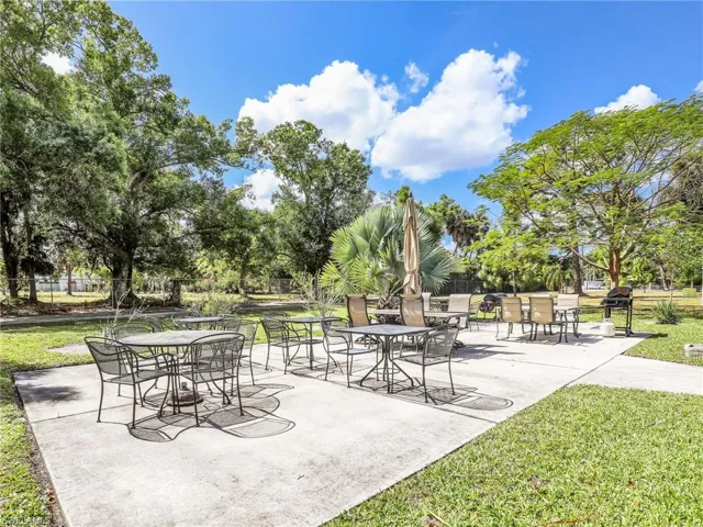 View of patio with a grill and outdoor dining space