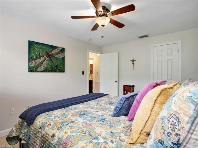 Bedroom with a ceiling fan and baseboards