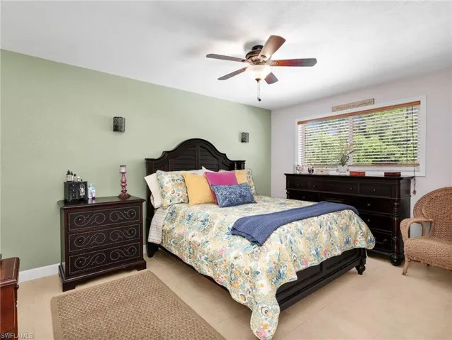 Bedroom with a ceiling fan and light tile patterned floors