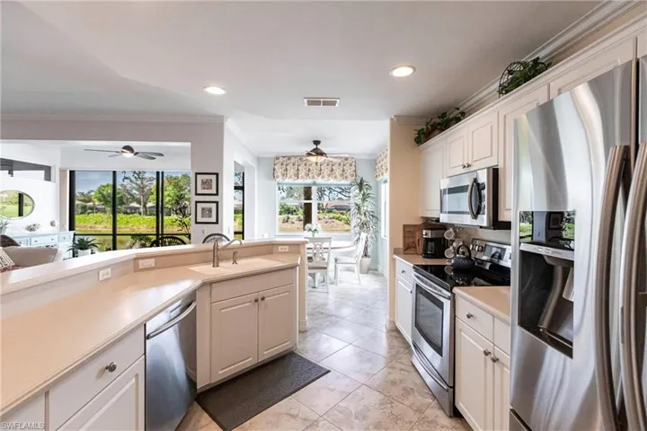 Kitchen featuring  stainless steel appliances, and white cabinets
