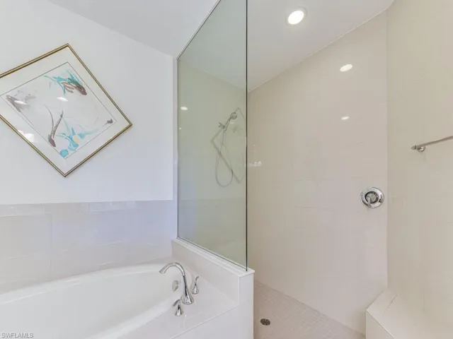 Full bath with a bath, walk in shower, and recessed lighting