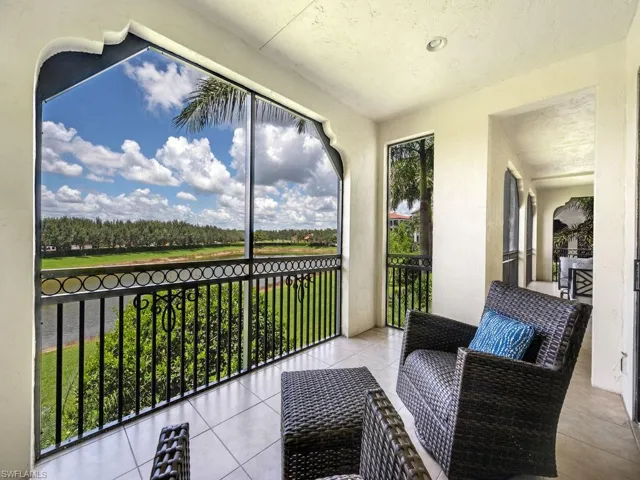 Sunroom featuring view of scattered trees
