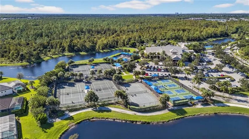 Drone / aerial view of a large body of water and a heavily wooded area