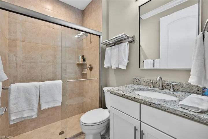 Full bathroom with vanity and a stall shower