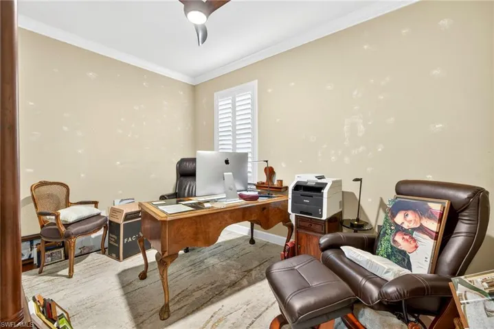 Home office with crown molding and ceiling fan