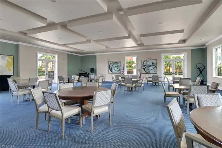 Dining room featuring ornamental molding, coffered ceiling, carpet, and beam ceiling