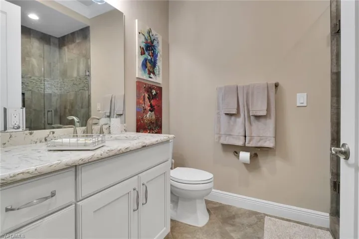 Bathroom with a stall shower and vanity