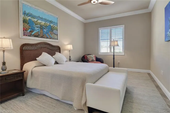 Bedroom with ornamental molding and a ceiling fan