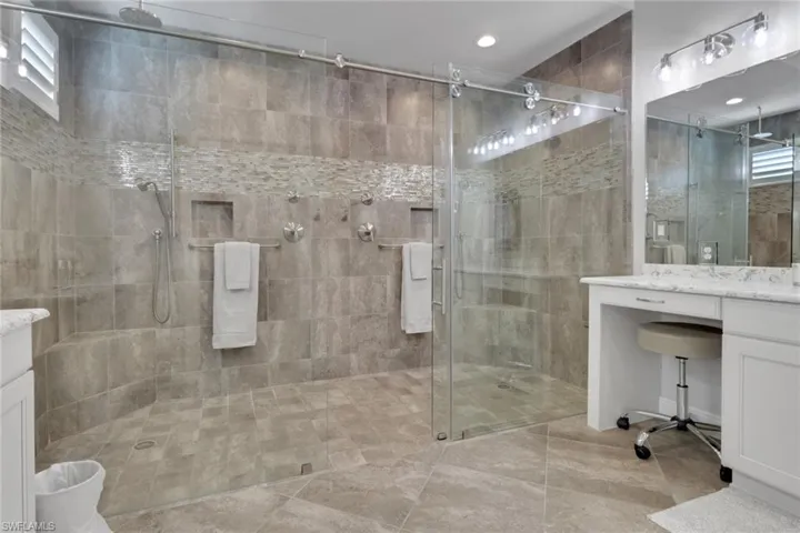 Primary Full bathroom with vanity, a shower stall, and light tile patterned floors