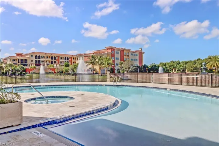 Community pool featuring a patio area and a hot tub