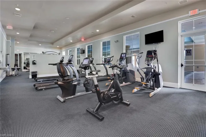 Gym with a raised ceiling and recessed lighting