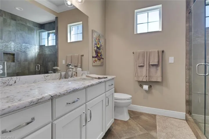 Full bath with vanity and a stall shower