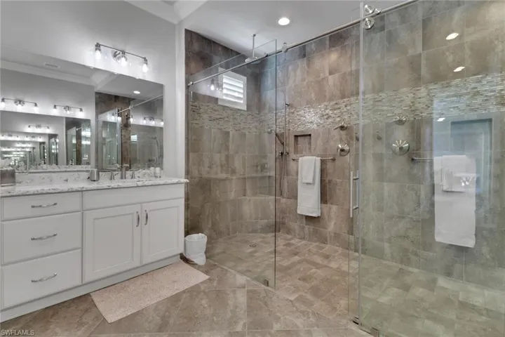 Primary Bathroom featuring vanity, a shower stall, and light tile patterned floors