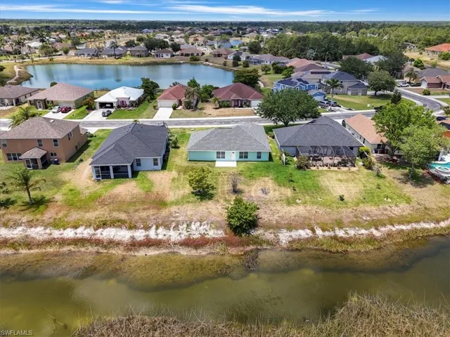 Birds eye view of property featuring a residential view and a water view