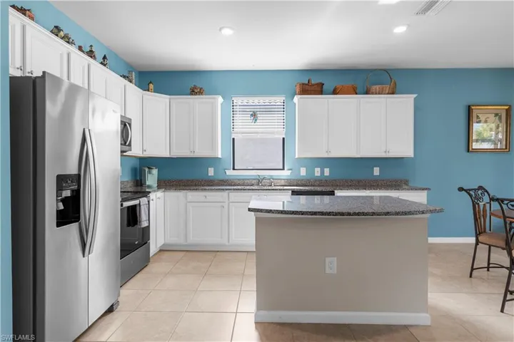 Beautiful Kitchen with Granite Counter tops, center island and Stainless Steel Appliances. 16009 Palmetto Prairie Drive.  Hampton Lakes at River Hall.