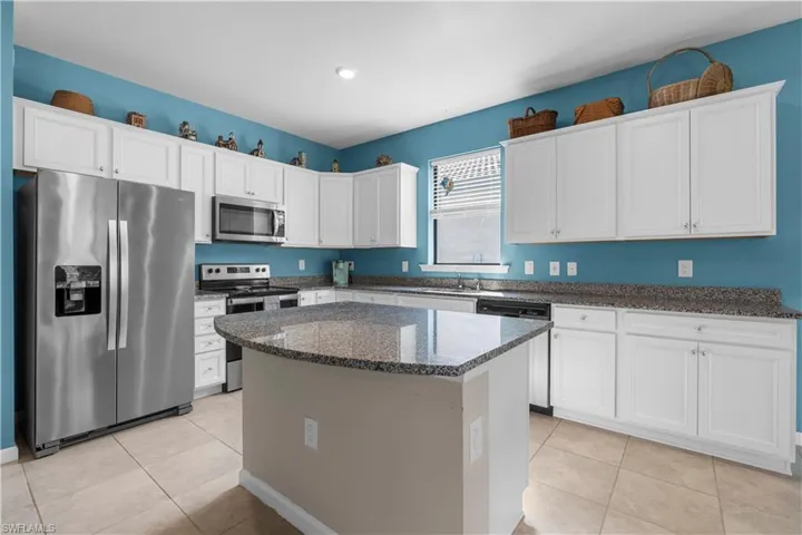 Beautiful Kitchen with Granite Counter tops, center island and Stainless Steel Appliances. 16009 Palmetto Prairie Drive.  Hampton Lakes at River Hall.