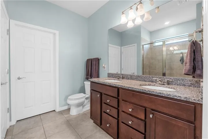 Master Bath with dual sinks and walk in shower. 16009 Palmetto Prairie Drive.  Hampton Lakes at River Hall.